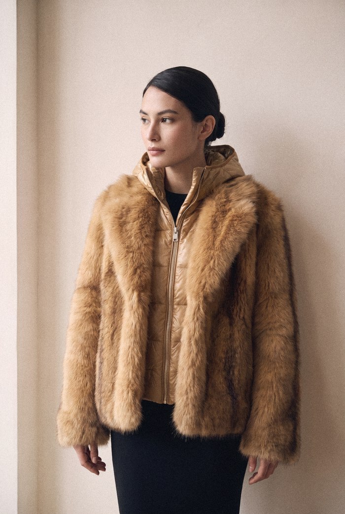 Faux fur jacket in camel with metallic puffer inner, worn