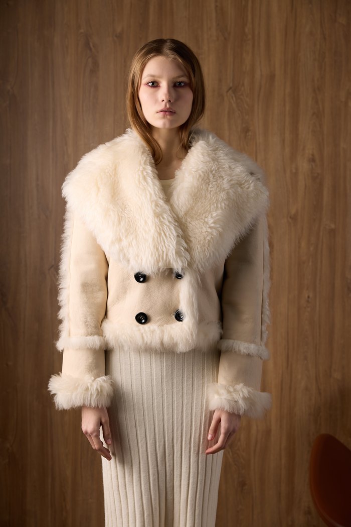 Double-breasted shearling jacket in beige, worn