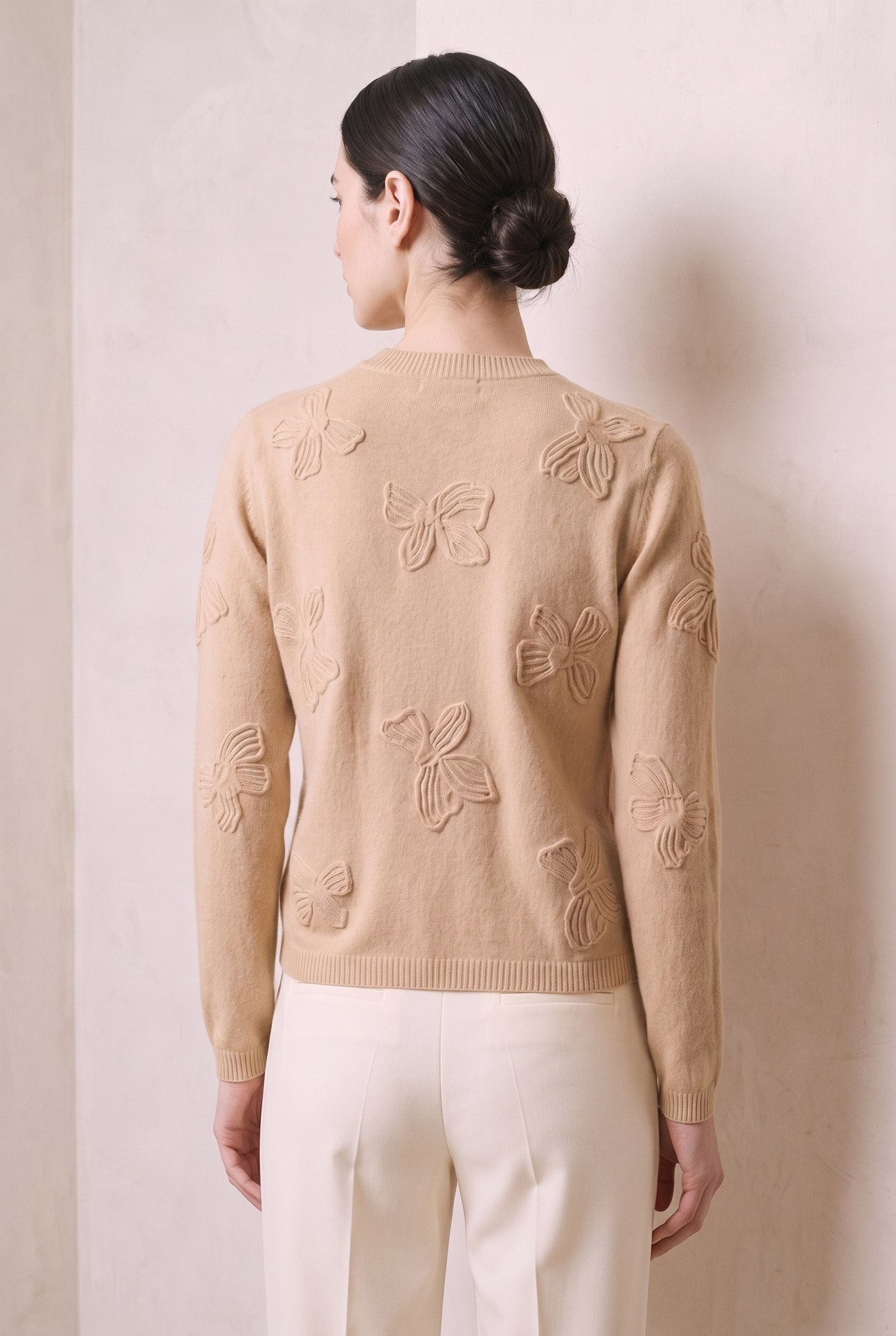 Style YRL568 oatmeal camel bow-motif sweater, back view